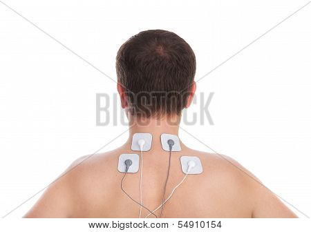 Man With Problems In The Neck And In The Spine Massage Makes Electrostimulator.