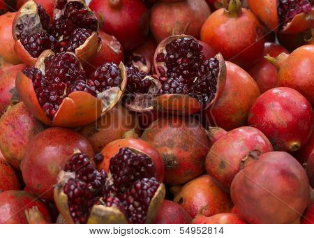 Pomme Grenate Apples, Some Cut Open, Others Not.