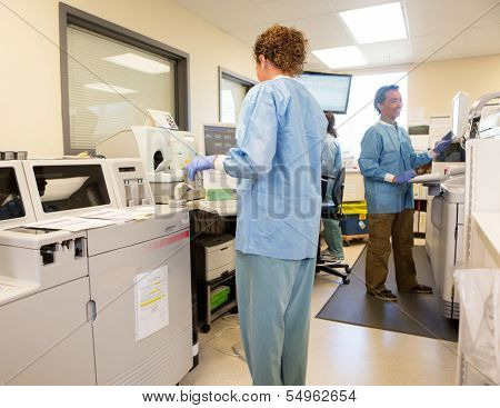 Team of lab technicians working in hospital lab