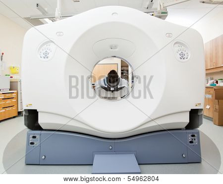 Female patient undergoing CT scan test in examination room
