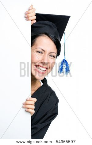 Graduating student peeps out from behind the copyspace, isolated on white