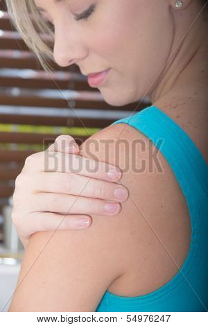 Female Patient Holding her painful Shoulder