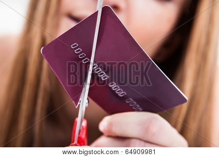 Close-up Of Hand Cutting Credit Card