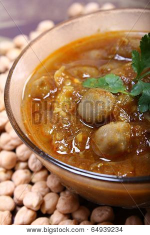 Close Up Of Indian Spicy Chana Masala With Raw Chickpeas Around