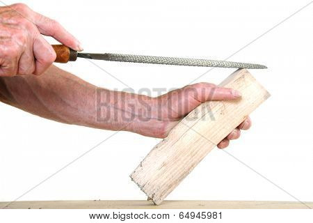 Joiner working on a piece of wood with a file