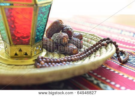 Close up of an arabic dates, lantern and rosary