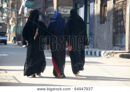 Three muslim woman walking on the street