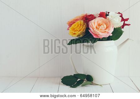 Colorful Roses In White Enamel Coffee Pot
