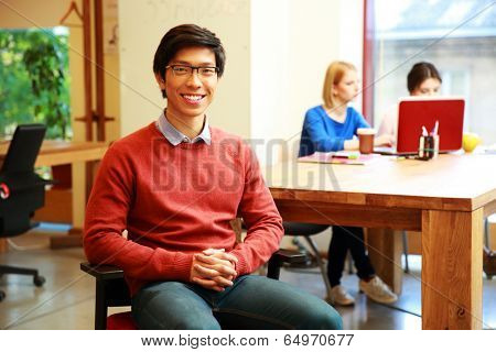 Smiling young asian student in classroom
