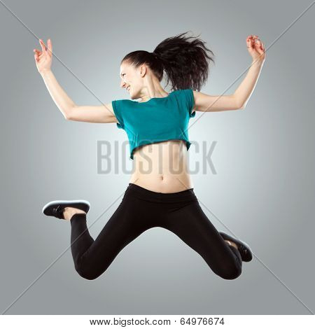 Professional dancer in studio on grey background
