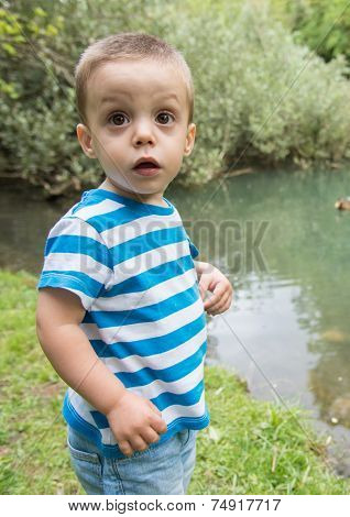 Child Beside A Lake