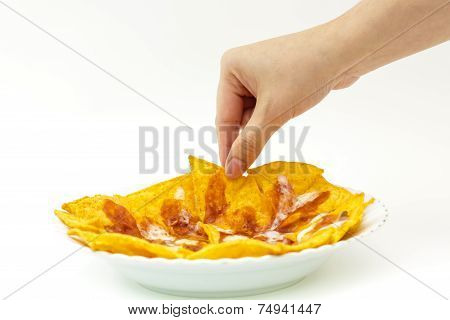Pincking Tortila Chips Covered With Cheese (nachos) From White Dish On White Background