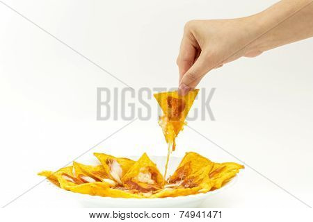 Pincking Tortila Chips Covered With Cheese (nachos) From White Dish On White Background