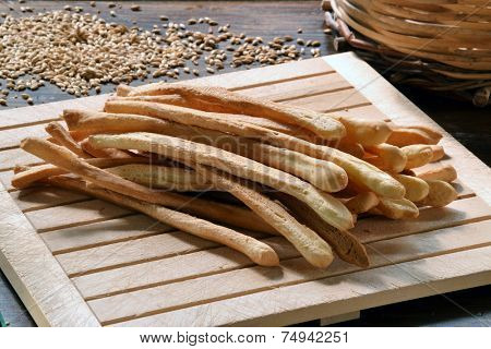 Grissini. fresh bread sticks in a basket on wooden table