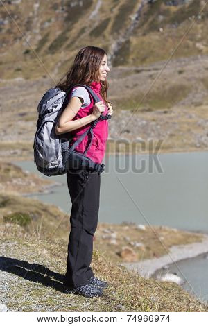 Young Woman Hiking In Nature Watching Lake Landscape