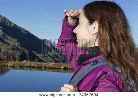 Woman Watching The Alps Mountain Landscape During A Hiking Trip