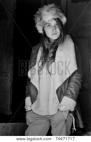 portrait photo of pretty model girl posing wearing fur hat and leather hat in monochrome