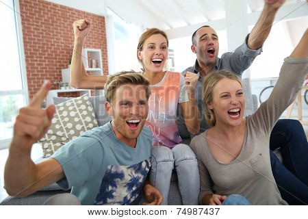 Roommates in apartment watching football game