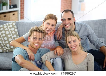 Roommates sitting together in couch