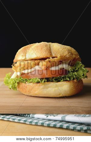 Tasty fish burger in corn bun