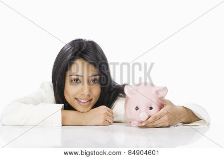 Portrait of a businesswoman with a piggy bank