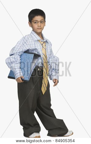 Portrait of a boy wearing oversized clothes and holding a file