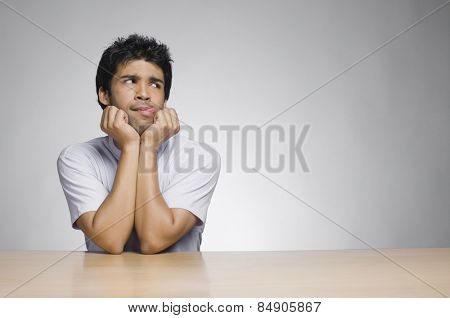 Man sticking his tongue out and looking sideways