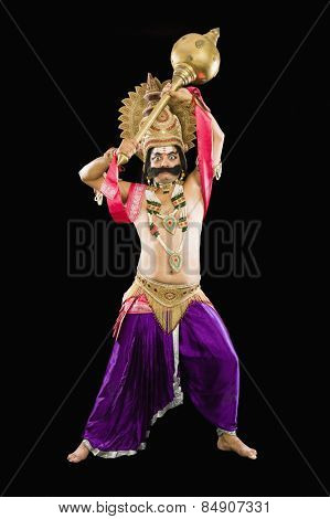 Portrait of a man dressed-up as Ravana the Hindu mythological character and holding a mace