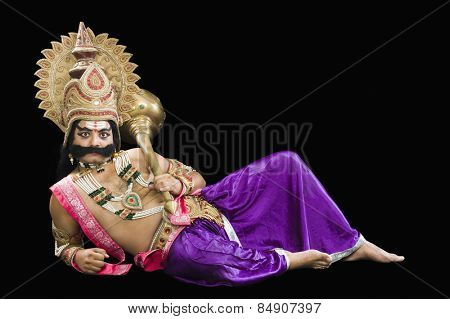 Portrait of a man dressed-up as Ravana the Hindu mythological character and holding a mace