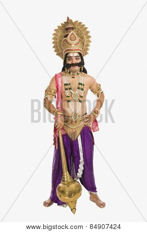 Portrait of a man dressed-up as Ravana the Hindu mythological character and holding a mace