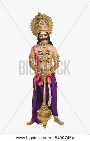 Portrait of a man dressed-up as Ravana the Hindu mythological character and holding a mace