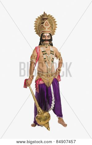 Portrait of a man dressed-up as Ravana the Hindu mythological character and holding a mace