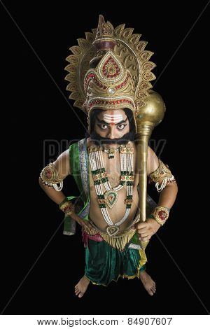 Portrait of a man dressed-up as Ravana and holding a mace