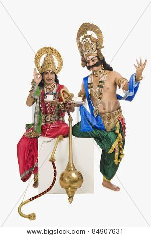 Two actors dressed-up as Rama and Ravana and drinking tea