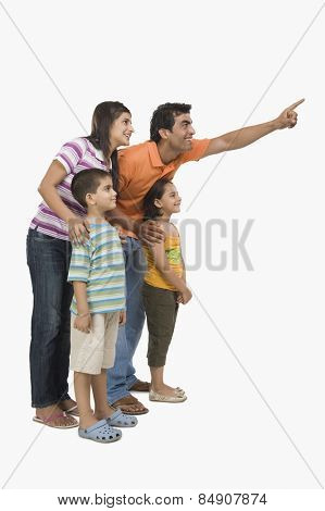 Parents standing with their children and pointing