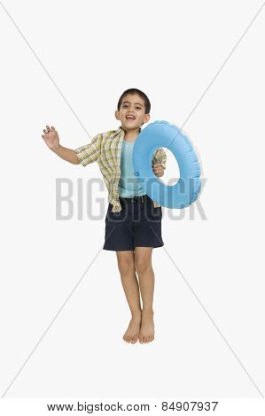 Portrait of a boy holding an inflatable ring