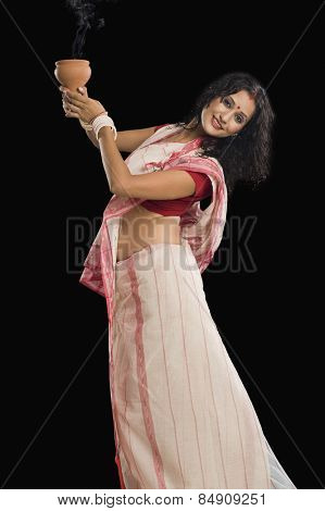 Young Bengali woman performing ritual dance