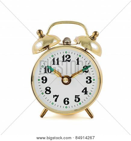 Golden mechanical alarm clock isolated