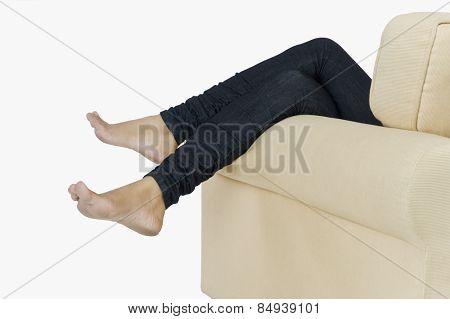 Low section view of a woman lying on a couch