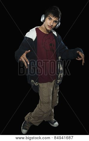 Portrait of a man listening to headphones and dancing