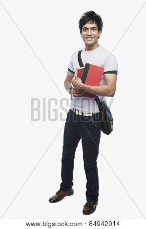 Portrait of a college student holding notebooks
