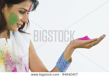 Close-up of a woman holding Holi colors