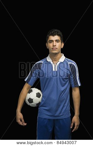 Soccer player holding a soccer ball