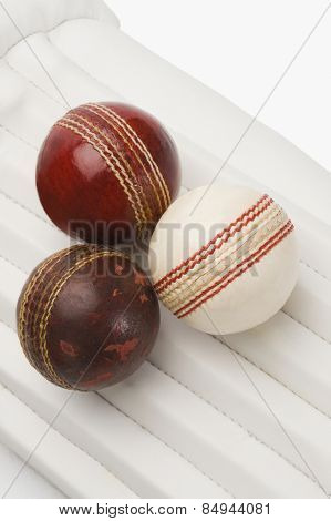 Close-up of cricket balls on cricket pads