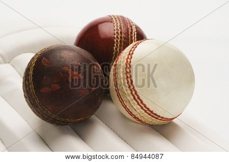 Close-up of cricket balls on cricket pads