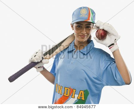 Portrait of a female cricketer holding a cricket bat and a ball