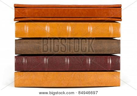 Stack of leather photo albums isolated on white background