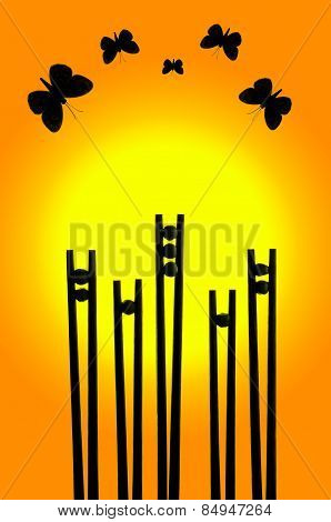 Butterflies silhouettes above flowers made from chopsticks and peas