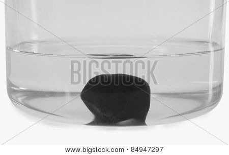 Close-up of a stone sunk in a bowl of water