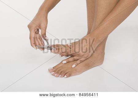 Woman clipping her toenails